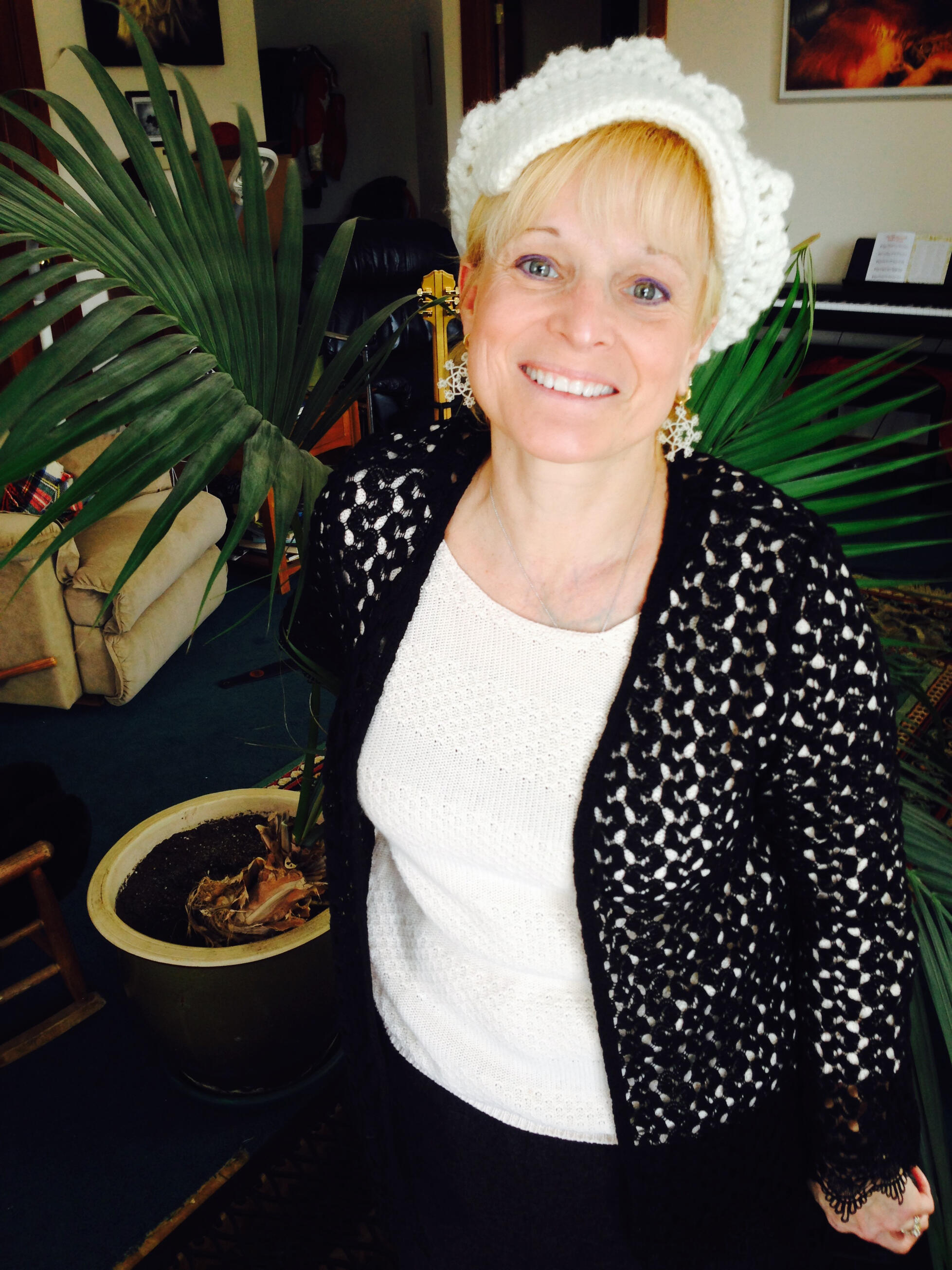 Veronica de Saint Phalle wearing tatted earrings thay she made.